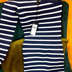 Navy and white one shoulder dress. With a pop of orange